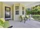 Inviting front porch with comfortable seating, plants, and a decorative front door at 628 Grand Cypress Way, Murrells Inlet, SC 29576