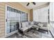 This cozy porch features a large sectional with modern cushions and privacy shades at 6309 Sweetwater Blvd., Murrells Inlet, SC 29576
