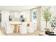 Bright dining area showcases a modern table with chairs and open floor plan to the kitchen at 6332 Swainson Street Sw, Ocean Isle Beach, NC 28469