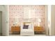 Bright Bedroom with patterned wallpaper, a white crib, and stylish side tables at 6347 Swainson Street Sw, Ocean Isle Beach, NC 28469