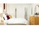 Bedroom with white walls, neutral furniture, and a view to closet and bathroom at 6347 Swainson Street Sw, Ocean Isle Beach, NC 28469