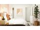 Bright bedroom showcasing a comfortable bed, dresser, and a decorative plant at 6366 Swainson Street Sw, Ocean Isle Beach, NC 28469