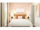 Cozy bedroom featuring a plush bed, stylish nightstands, and calming peach color palette at 6366 Swainson Street Sw, Ocean Isle Beach, NC 28469