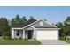 Charming single-story home featuring a gray exterior, manicured lawn, and attached two-car garage at 6366 Swainson Street Sw, Ocean Isle Beach, NC 28469