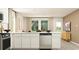 Bright, open kitchen with white countertops, stainless steel dishwasher and views to the living area at 6366 Swainson Street Sw, Ocean Isle Beach, NC 28469