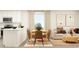 Open-concept living space featuring a dining area, sofa, and modern kitchen with white countertops at 6366 Swainson Street Sw, Ocean Isle Beach, NC 28469