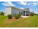 Well-maintained backyard with lush grass and a screened-in porch for relaxation at 6378 Torino Lane, Myrtle Beach, SC 29572