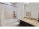 Well-lit bathroom with granite countertops, dark cabinetry, and a shower-tub combination at 6378 Torino Lane, Myrtle Beach, SC 29572