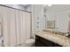 Well-lit bathroom featuring granite countertops, a shower curtain, and neutral color scheme at 6378 Torino Lane, Myrtle Beach, SC 29572