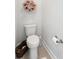 Cozy half bathroom featuring a toilet, decorative wreath, and toilet paper holder at 6378 Torino Lane, Myrtle Beach, SC 29572