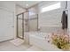 Modern bathroom featuring a glass-enclosed shower, soaking tub, and stylish tile accents at 6378 Torino Lane, Myrtle Beach, SC 29572