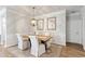 Formal dining area with a light wood table, comfortable seating, and stylish decor at 6378 Torino Lane, Myrtle Beach, SC 29572