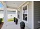 Cozy front porch with modern details, including decorative shrubbery in planters and a view of the house exterior at 6378 Torino Lane, Myrtle Beach, SC 29572