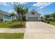 Beautiful home with a well-maintained lawn, crepe myrtle trees, and a two-car garage, showcasing classic charm at 6378 Torino Lane, Myrtle Beach, SC 29572