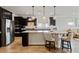Modern kitchen features a stainless steel refrigerator, granite countertops, and barstool seating at 6378 Torino Lane, Myrtle Beach, SC 29572