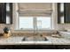 Close up of the kitchen sink with granite countertops and a neutral colored window shade at 6378 Torino Lane, Myrtle Beach, SC 29572