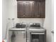 Convenient laundry room with washer, dryer, storage cabinets, and ironing board at 6378 Torino Lane, Myrtle Beach, SC 29572