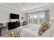 Luxurious main bedroom suite with water view, large windows, a tray ceiling, and a stylish chandelier at 6378 Torino Lane, Myrtle Beach, SC 29572