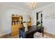 Well-lit office space showcasing a vintage desk, wooden bookshelf, and elegant light fixture at 6378 Torino Lane, Myrtle Beach, SC 29572