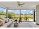 Inviting screened porch with comfortable seating and serene views of the landscaped backyard and pond at 6378 Torino Lane, Myrtle Beach, SC 29572