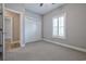 Bedroom with neutral gray walls, plush carpet, bright window with plantation shutters, and a closet with white doors at 648 Sunnyside Dr. # 102, Murrells Inlet, SC 29576