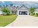 Inviting single-Gathering home with a lush lawn, mature trees and an open garage at 648 Sunnyside Dr. # 102, Murrells Inlet, SC 29576