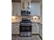Kitchen with stainless steel appliances, white cabinets, subway tile backsplash, and granite countertops at 648 Sunnyside Dr. # 102, Murrells Inlet, SC 29576
