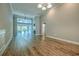 Spacious living room with high ceilings, wood floors, a fireplace, recessed lighting, and a view to the sunroom at 648 Sunnyside Dr. # 102, Murrells Inlet, SC 29576
