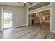 Bright living room with wood floors, a fireplace, and an open floor plan leading to kitchen and patio at 648 Sunnyside Dr. # 102, Murrells Inlet, SC 29576