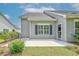 Charming patio area with light-gray vinyl siding and green landscaping near the rear entrance at 648 Sunnyside Dr. # 102, Murrells Inlet, SC 29576
