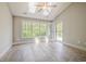 Bright sunroom featuring a ceiling fan and a skylight with a window door to the backyard at 648 Sunnyside Dr. # 102, Murrells Inlet, SC 29576