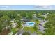 Aerial view showcasing pool, tennis courts, and recreational area surrounded by lush greenery at 6681 Wisteria Dr., Myrtle Beach, SC 29588