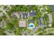 Aerial view showcasing boat storage, a pool, and tennis courts surrounded by trees at 6681 Wisteria Dr., Myrtle Beach, SC 29588