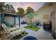Backyard patio featuring a gazebo, outdoor seating, a grill, and manicured lawn at 6681 Wisteria Dr., Myrtle Beach, SC 29588