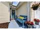 Cozy front porch with a bench, plants, and a decorative wreath on the front door at 6681 Wisteria Dr., Myrtle Beach, SC 29588
