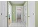 Hallway with tile floors and doorways that lead to various rooms, including a bathroom at 6681 Wisteria Dr., Myrtle Beach, SC 29588
