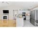 Bright kitchen with an island, white cabinets, modern appliances, and fireplace, creating a perfect gathering spot at 6681 Wisteria Dr., Myrtle Beach, SC 29588
