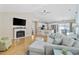 Open-concept living area with wood floors, a fireplace, and access to the kitchen and dining area at 6681 Wisteria Dr., Myrtle Beach, SC 29588