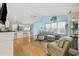 Spacious living room with wood flooring, high ceilings, and seamless transition to the kitchen area at 6681 Wisteria Dr., Myrtle Beach, SC 29588