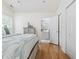 Inviting bedroom with hardwood floors, a tranquil color scheme, and a glimpse of the en-suite bathroom at 6681 Wisteria Dr., Myrtle Beach, SC 29588