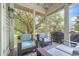 Enjoy this screened-in porch with comfortable furniture for relaxing and watching the grill on the porch at 70 Beachwalker Ct., Georgetown, SC 29440