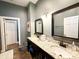 Stylish bathroom boasting dual sinks with granite countertops and dark wood cabinetry at 70 Beachwalker Ct., Georgetown, SC 29440