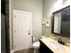 Well-lit bathroom featuring a toilet, framed nautical art, and vanity with a mirror and countertop at 70 Beachwalker Ct., Georgetown, SC 29440