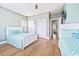 This bedroom features matching beds, light hardwood floors, and a full closet with views into an adjacent bedroom at 70 Beachwalker Ct., Georgetown, SC 29440