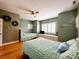 A bedroom with two beds, shuttered windows, wood floors, and coastal decor with built in storage underneath the windows at 70 Beachwalker Ct., Georgetown, SC 29440