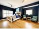 Cozy main bedroom features hardwood floors, natural light, and stylish decor at 70 Beachwalker Ct., Georgetown, SC 29440