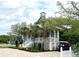 Charming coastal home with a front porch, a well-manicured yard, and convenient golf cart parking at 70 Beachwalker Ct., Georgetown, SC 29440