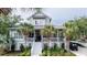 Charming two-story coastal home featuring a welcoming front porch, lush landscaping, and a convenient golf cart at 70 Beachwalker Ct., Georgetown, SC 29440