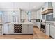 Bright kitchen featuring custom cabinets, a granite island with wine rack, and stainless steel appliances at 70 Beachwalker Ct., Georgetown, SC 29440
