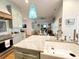 Open concept kitchen features granite countertops, a farmhouse sink, stainless appliances, and custom cabinetry at 70 Beachwalker Ct., Georgetown, SC 29440